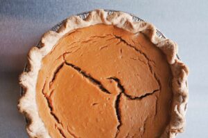 Image of a pumpkin pie, with a cracked surface